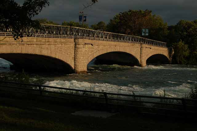 A bridge on the US side connects one island to another, the river rushing underneath